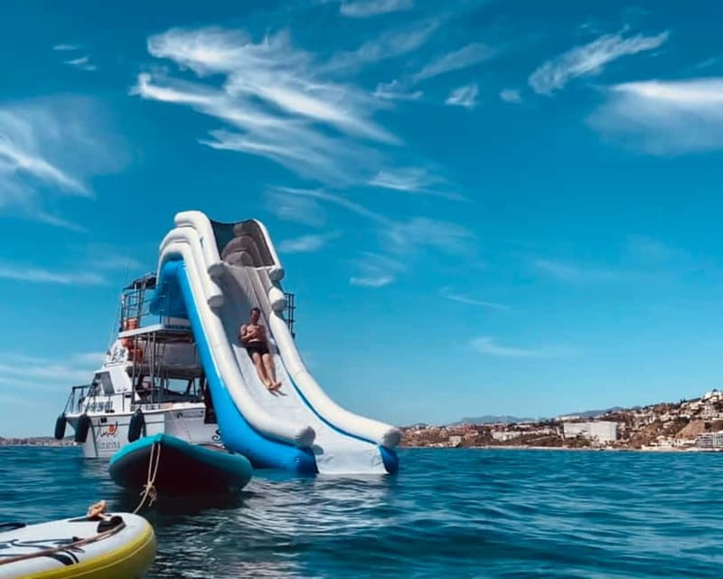 Benalmádena Boat Tour with Snorkeling, Water Slide and Lunch - Leaving from Benalmádena and finding the dolphins