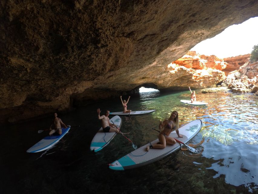 Ibiza: SUP & Snorkel Boat Tour with Caves, Drinks & Photos - A scenic stop with an aperitif