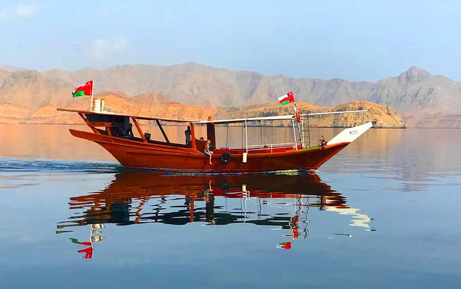 Khasab: Dolphin Watching Day Tour with Snorkeling & Lunch - Khor Sham by dhow, with dolphins in the distance
