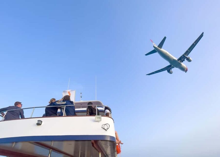 Larnaca Bay Cruise with Snorkeling - Mackenzie Beach, clear water, and planes overhead