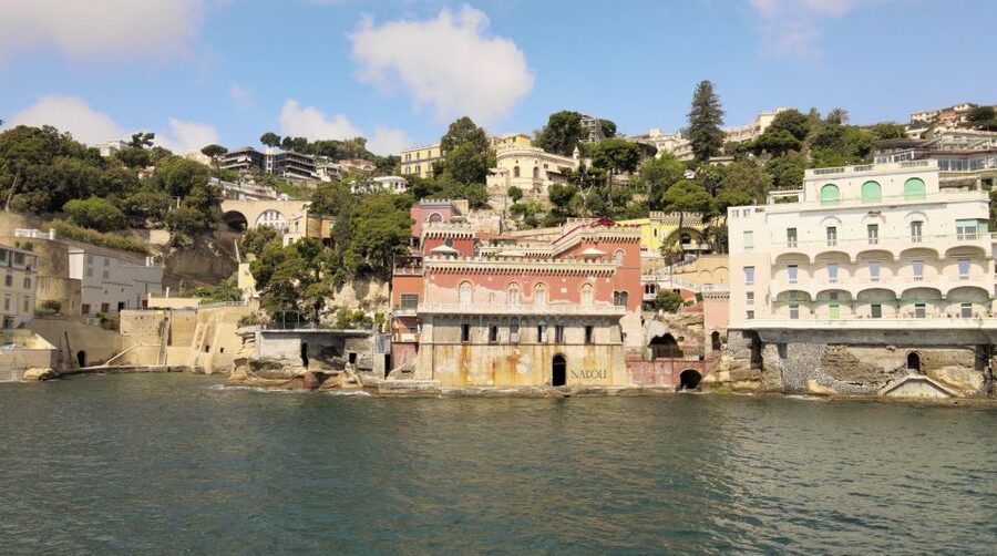 Naples: Castel dell'Ovo Boat Tour with Snorkeling & Aperitif - Palazzo Donn’Anna and Naples’ grand shoreline