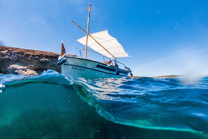 Private 4-hour Mediterranean Boat Tour in Ibiza with Snorkeling - Cala Saladeta adds caves and a rougher shoreline