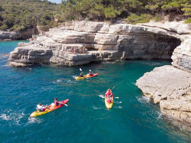 Pula: Sea Adventure – Boat, Kayak, Snorkeling & Cliff Jumps - Kayaking beside Pula’s highest cliffs