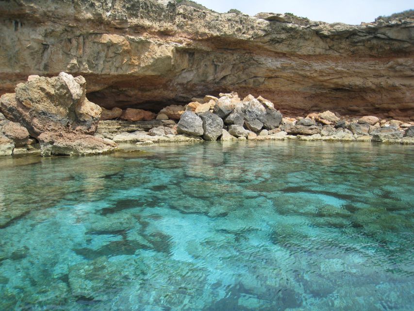 S'Espalmador and Formentera: Snorkeling Trip by RIB Boat - Cala Saona: red cliffs beside turquoise water
