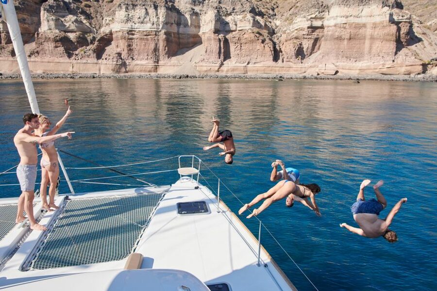 Santorini Gold Catamaran Cruise with Snorkel, BBQ & Open Bar - Leaving Vlychada with meze and a safety briefing